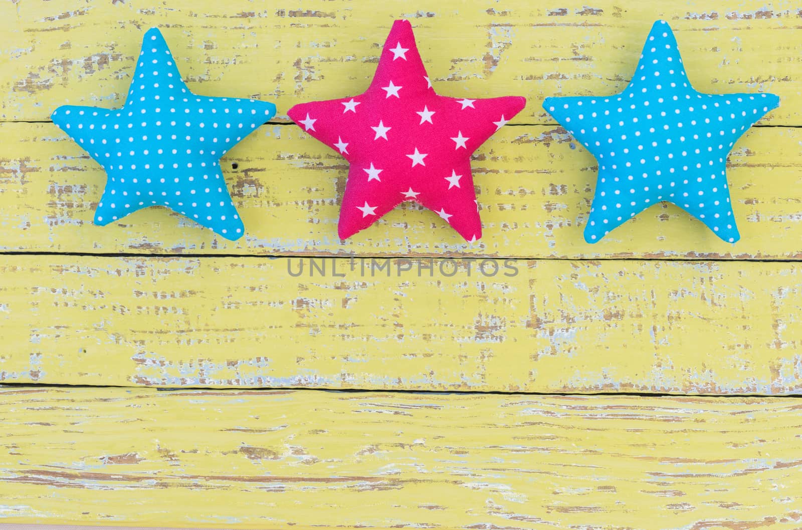 Fabric stars decor on vintage wooden background with copy space