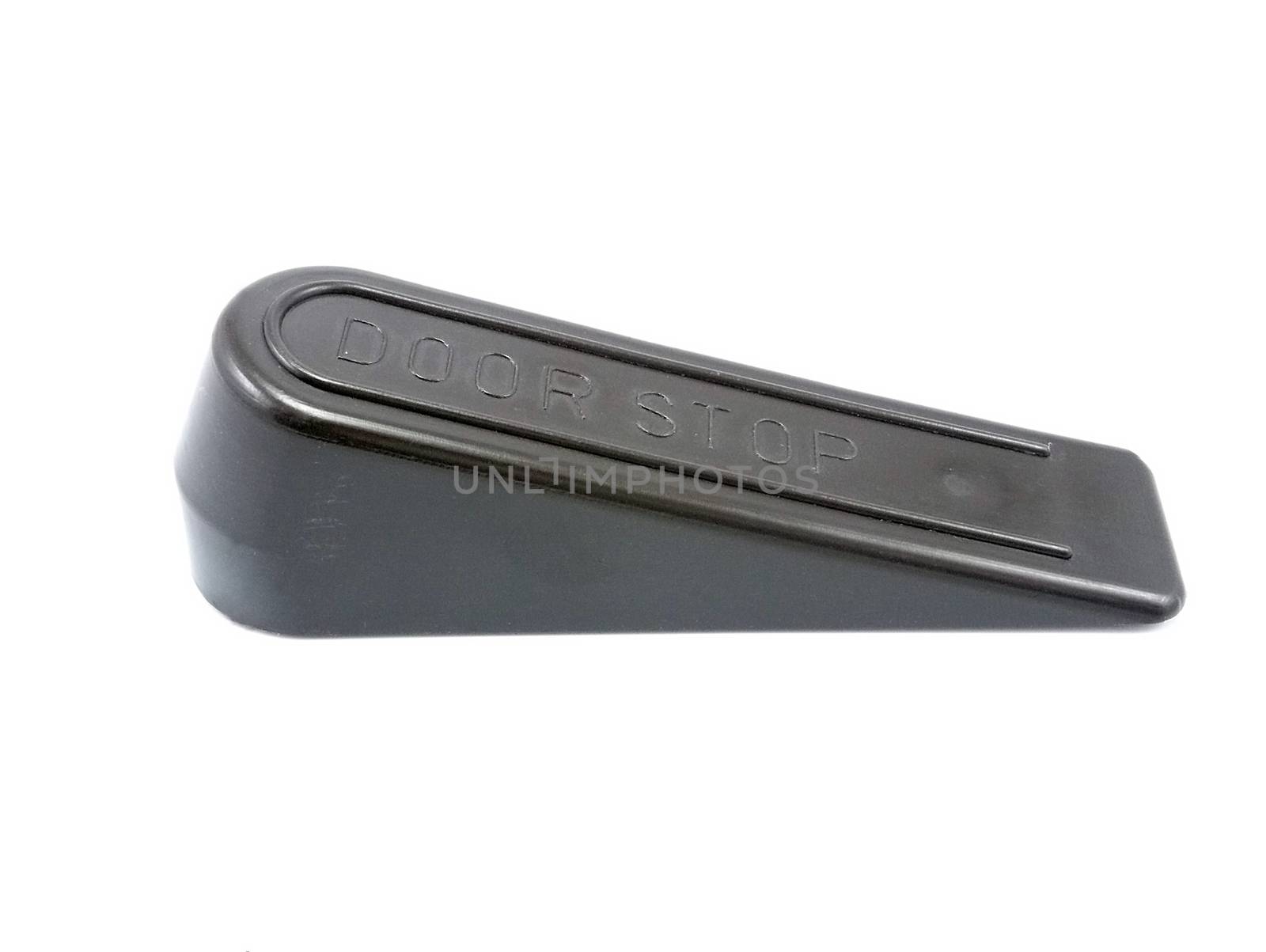 Black hard inclined plastic door stopper with ridges use to put underneath the door
