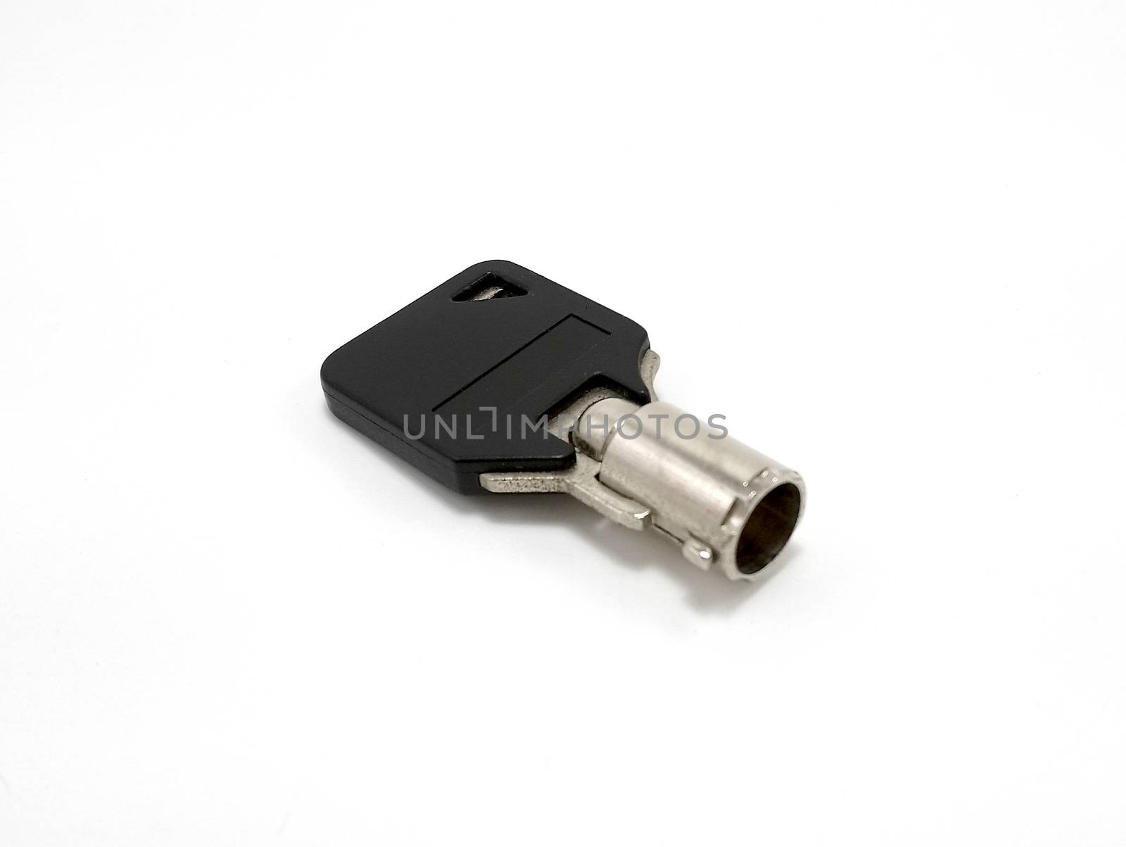 small black tubular key use to lock and unlock keyhole