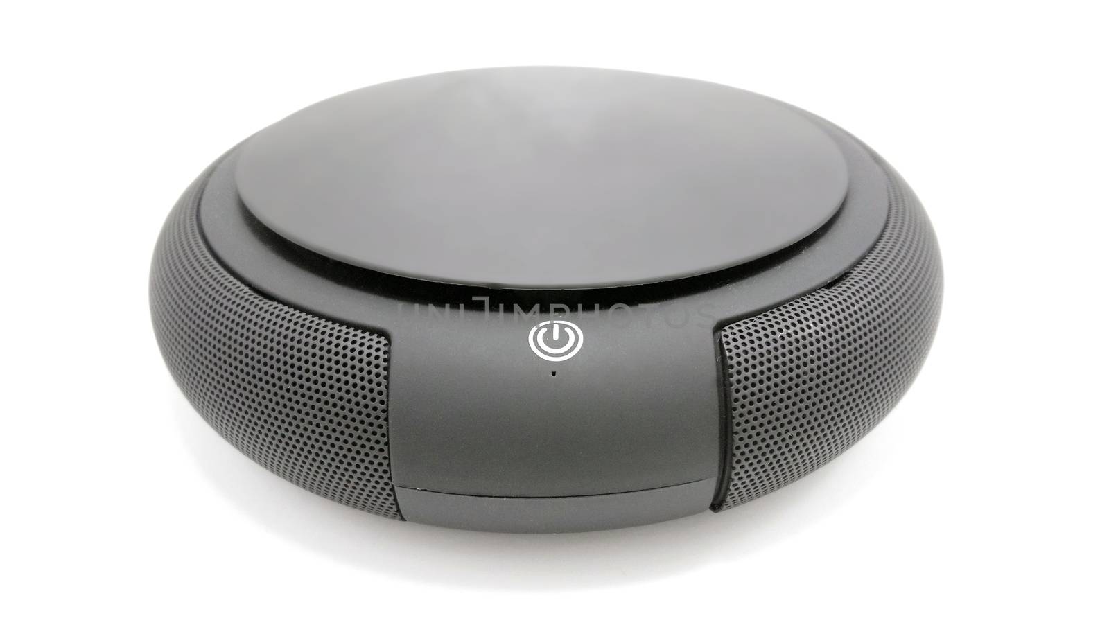 Black circular wireless sound speaker use to listen music and entertainment