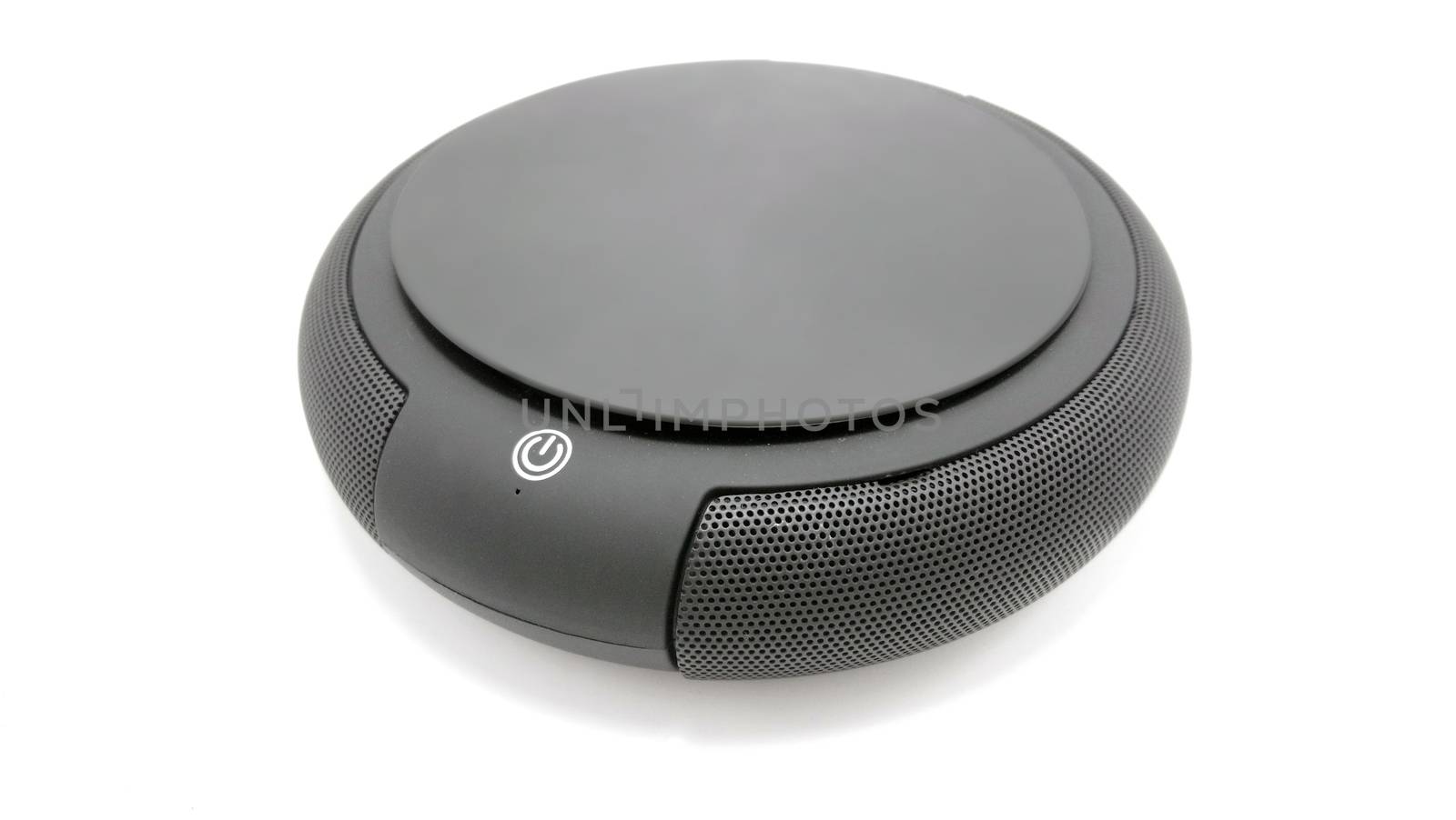 Black circular wireless sound speaker use to listen music and entertainment