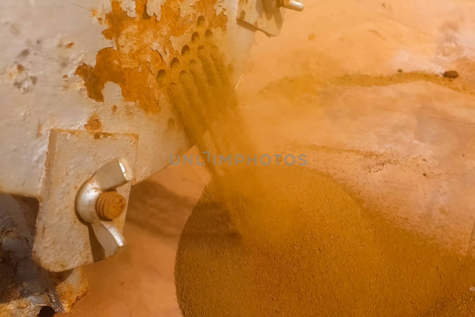 Ground rock is poured out of millstones.