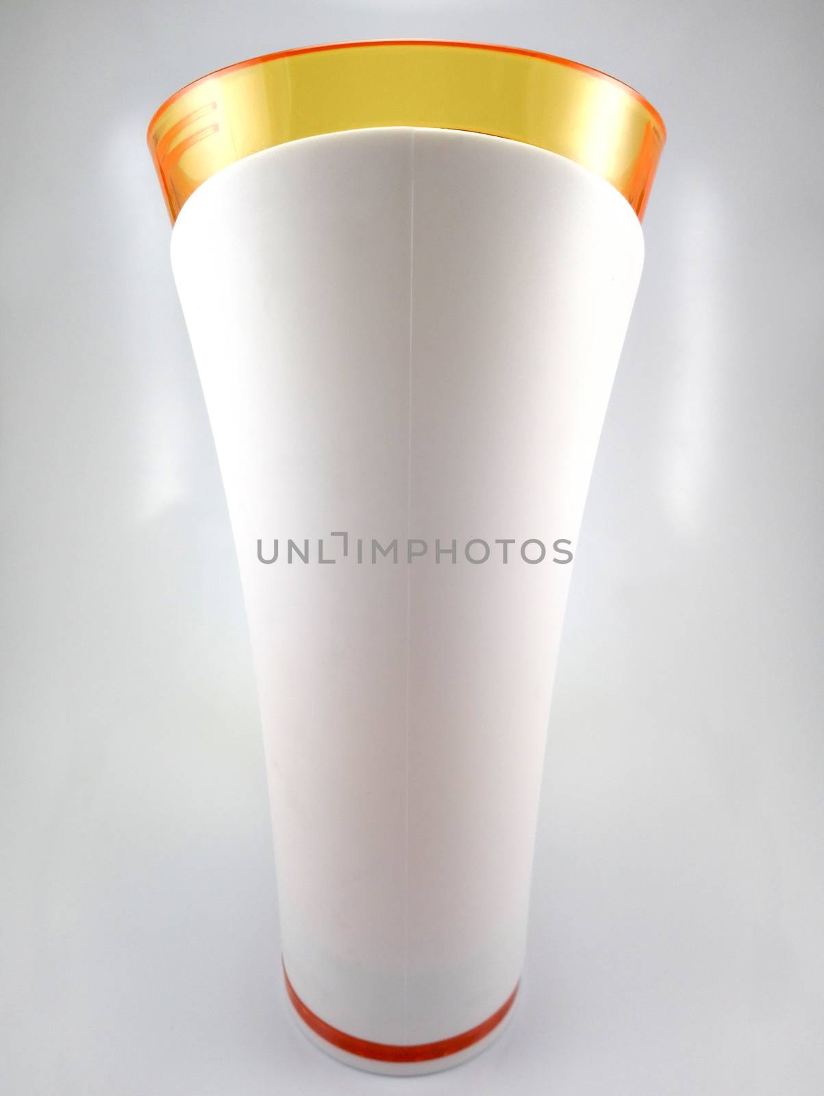 Orange and white color long plastic drinking cup with handle use to drink water content 