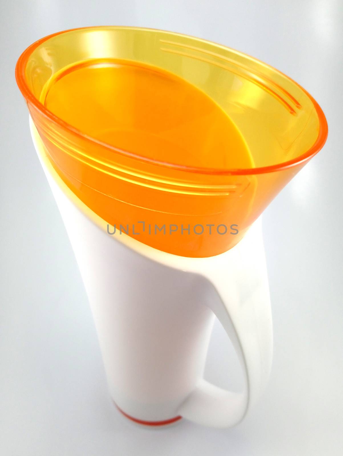 Orange and white color long plastic drinking cup with handle use to drink water content 