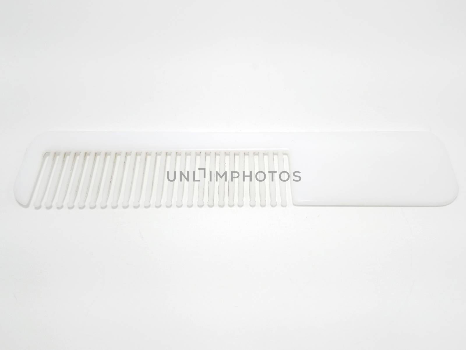 White disposable plastic hair comb use to fix and style the hair
