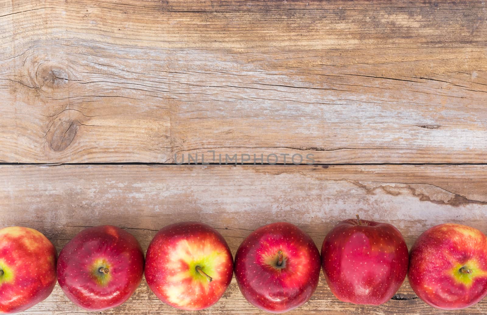 Fresh red apples fruits on rustic wood background with copy space