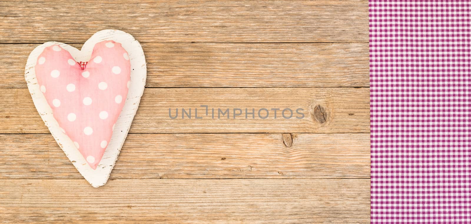 Romantic pink heart on wooden background with copy space