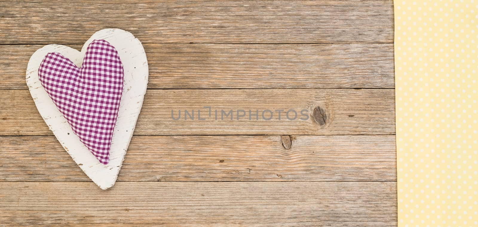 Rustic purple heart on wooden background with copy space