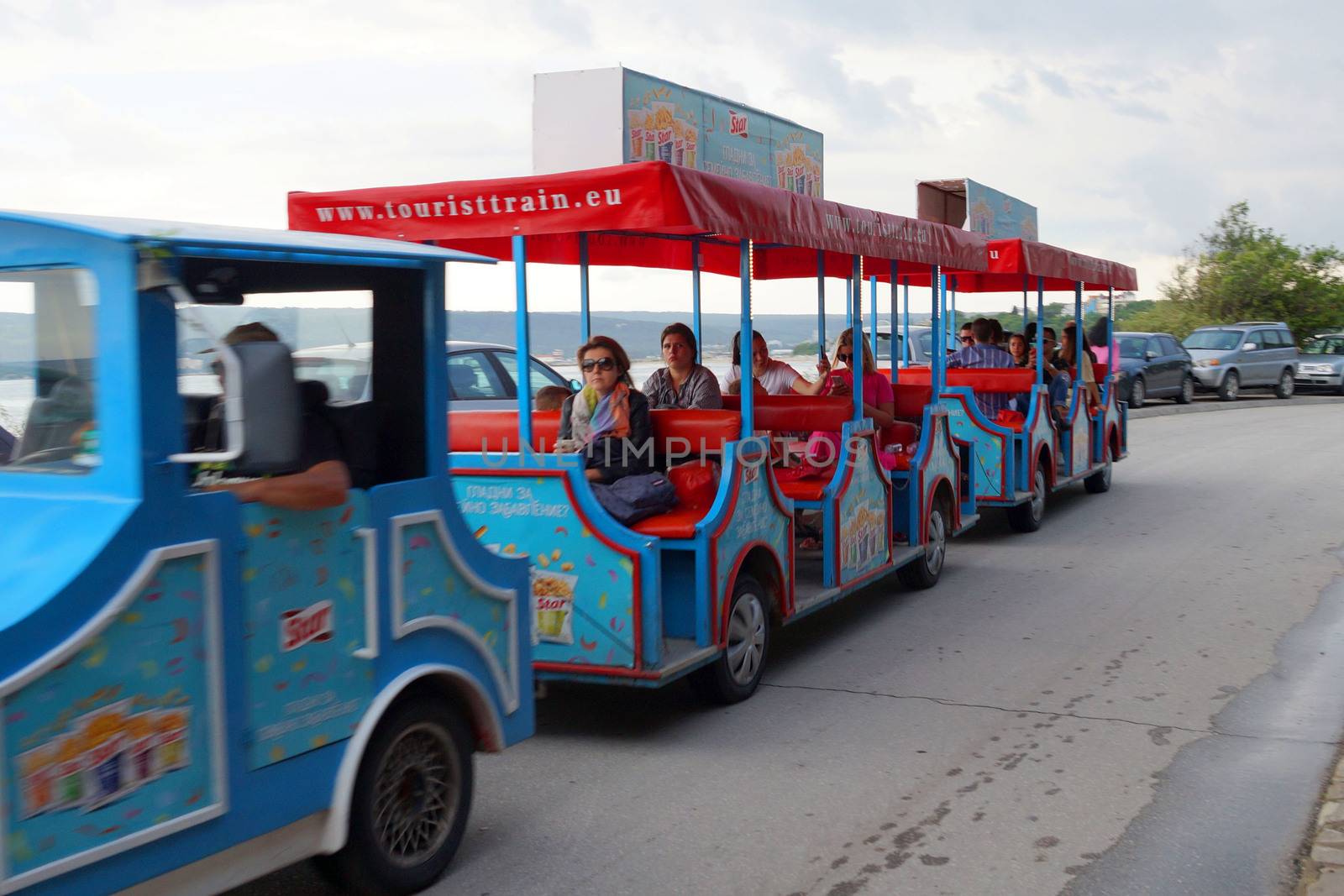 Varna, Bulgaria - June, 24, 2020: pleasure train with tourists on the embankment of Varna. by Annado