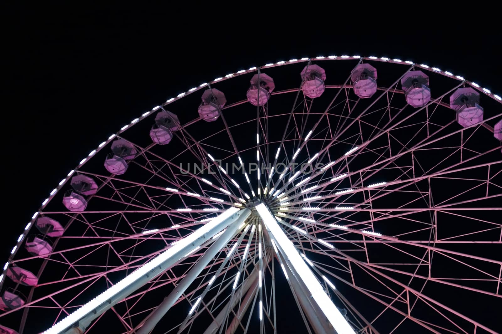 luminous ferris wheel against the night sky