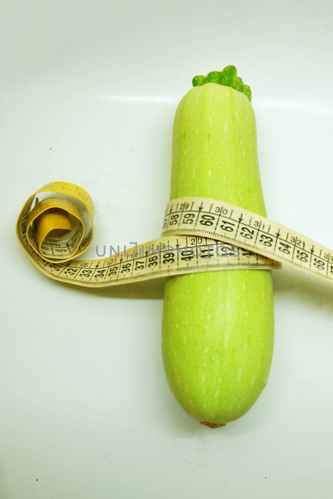 soft measuring linear zucchini wrapped around as a symbol of healthy eating