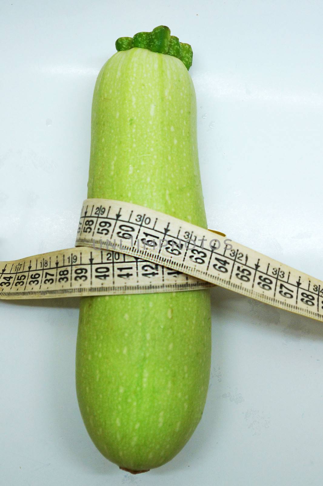 soft measuring linear zucchini wrapped around as a symbol of healthy eating