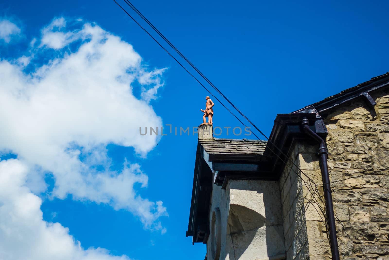 roof top statue of a man on Beast Banks Kendal Cumbria UK by paddythegolfer