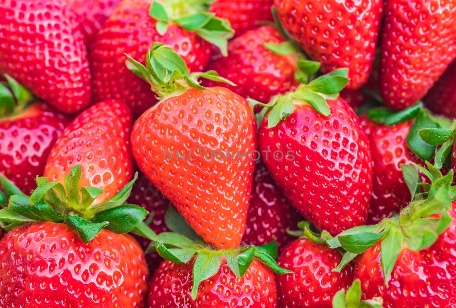 Fresh red strawberries background, close-up