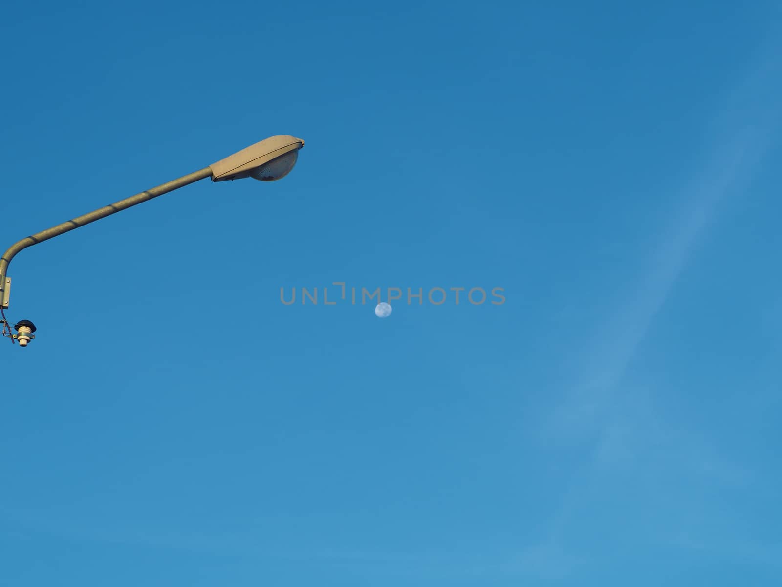 The street light tower on the background is blue sky And there is a small moon in the middle
Energy and nature concepts.
Minimal image.