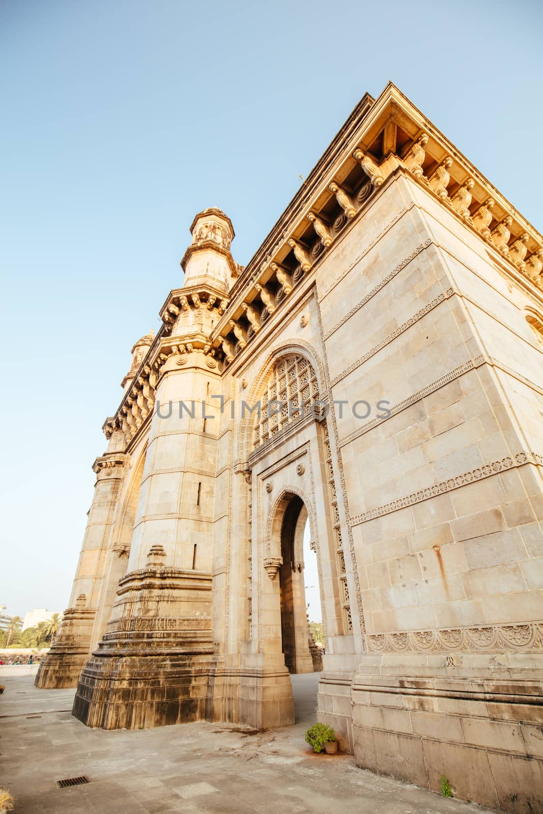 Mumbai, India - 9 November: The Gateway of India with tourists and sellers on a clear autumn evening