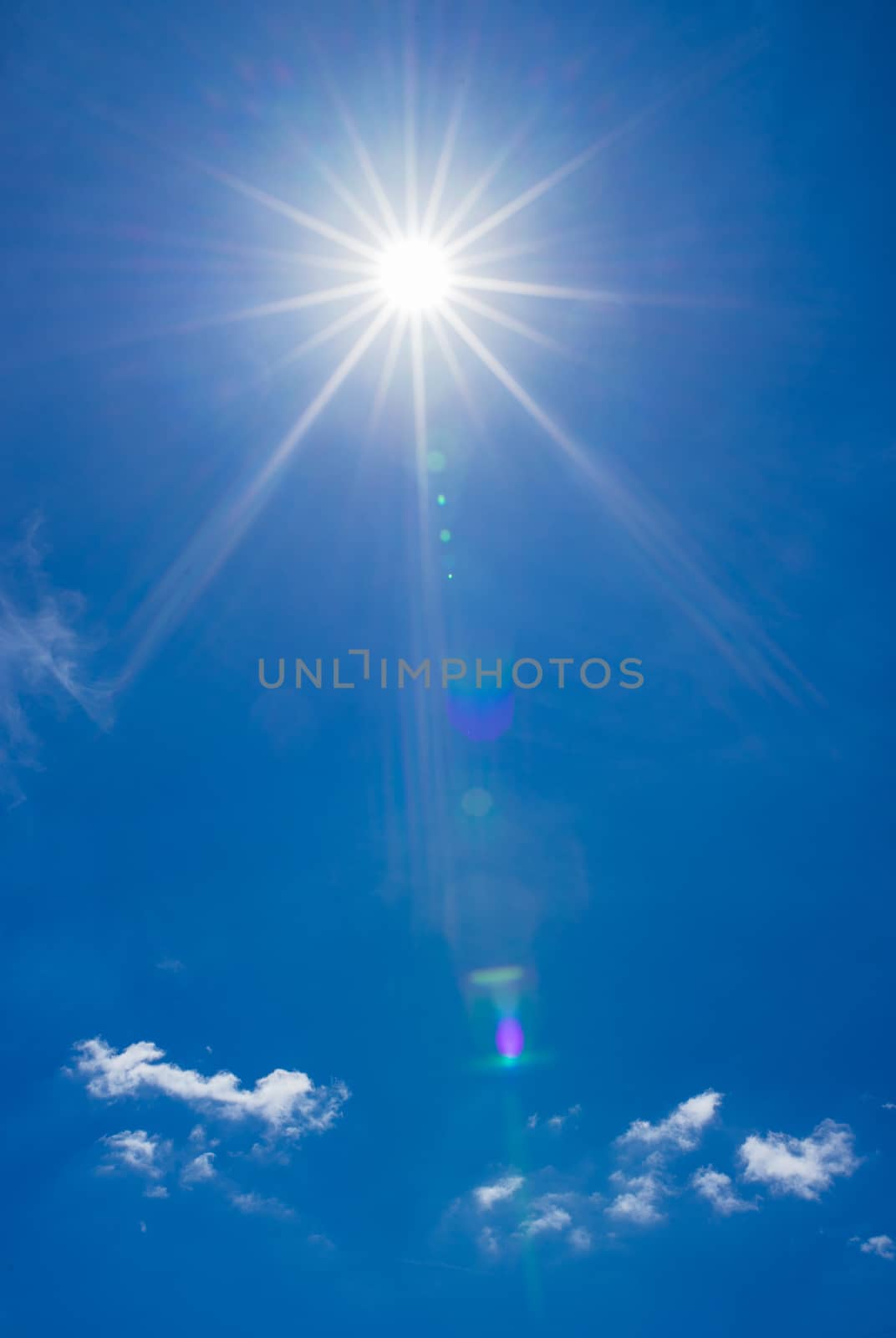 Sunrays on deep blue sky background by Vulcano