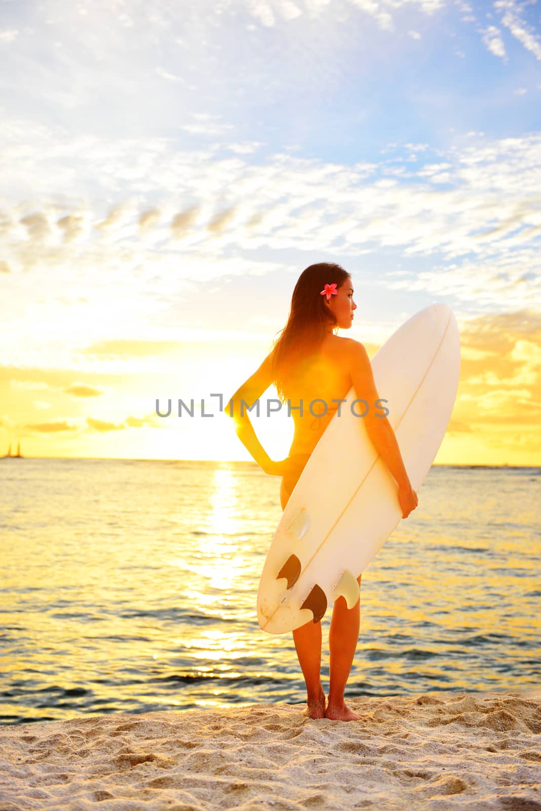 Surfing surfer girl looking at ocean beach sunset by Maridav