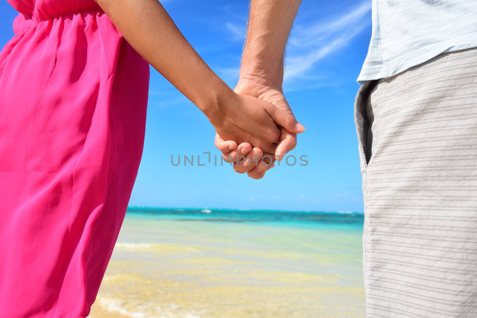 Holding hands romantic newlyweds couple on beach by Maridav