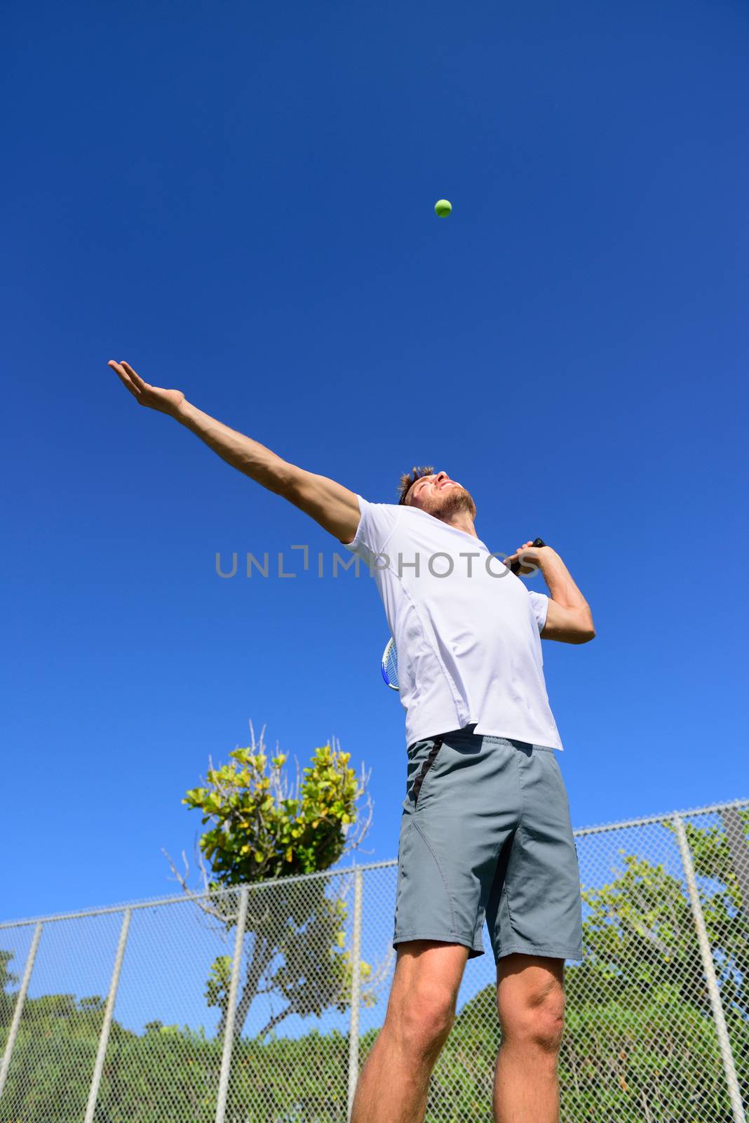 Tennis player serving playing outdoors - sport man by Maridav