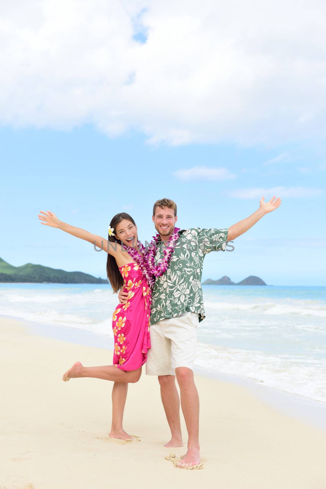 Happy Hawaii fun couple on beach holiday in Hawaii by Maridav