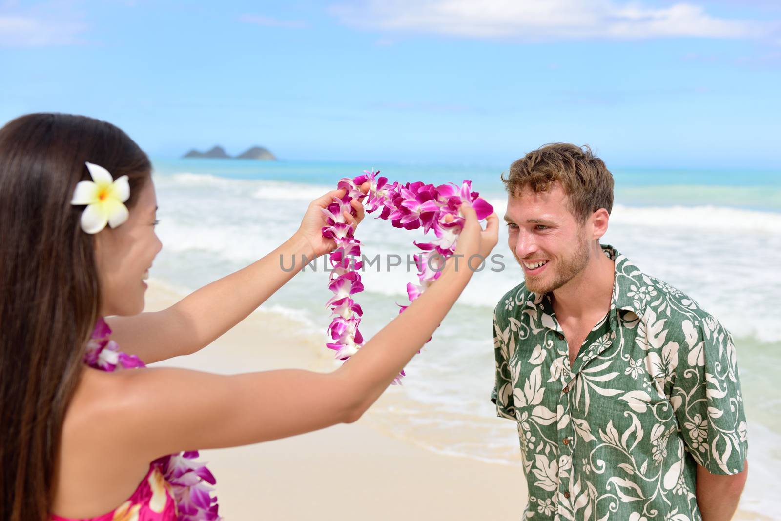 Hawaii woman giving lei garland welcoming tourist by Maridav