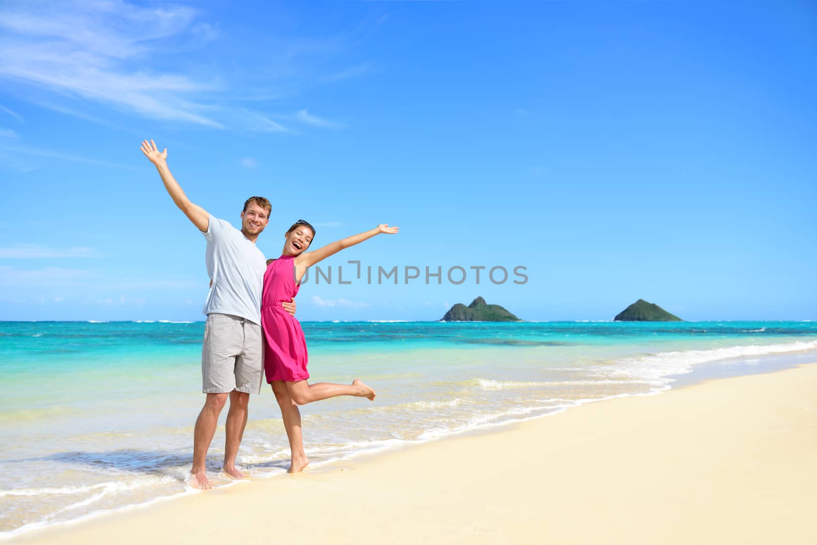 Beach vacation happy carefree couple arms raised by Maridav