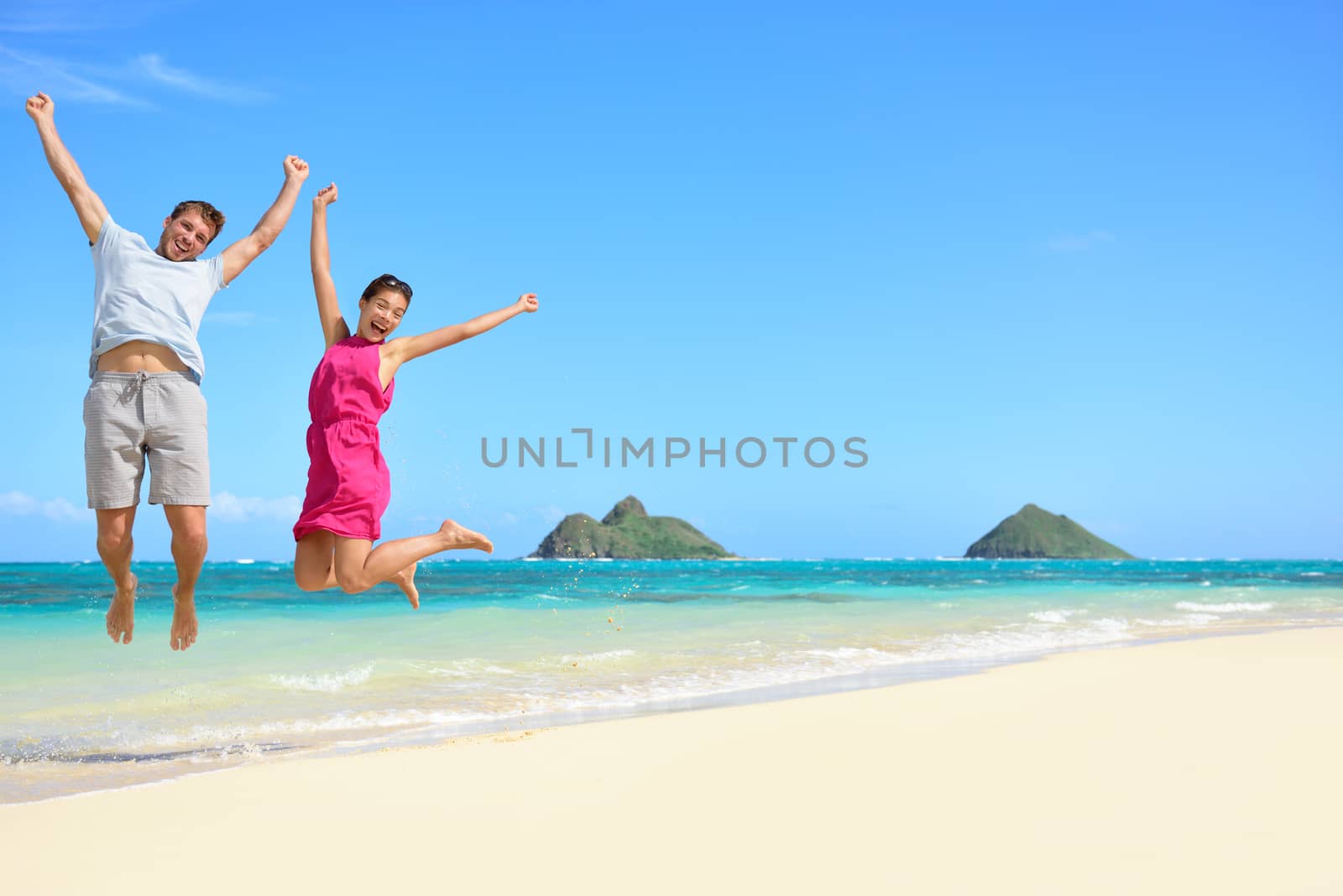 Happy fun tourists couple jumping Beach vacation by Maridav
