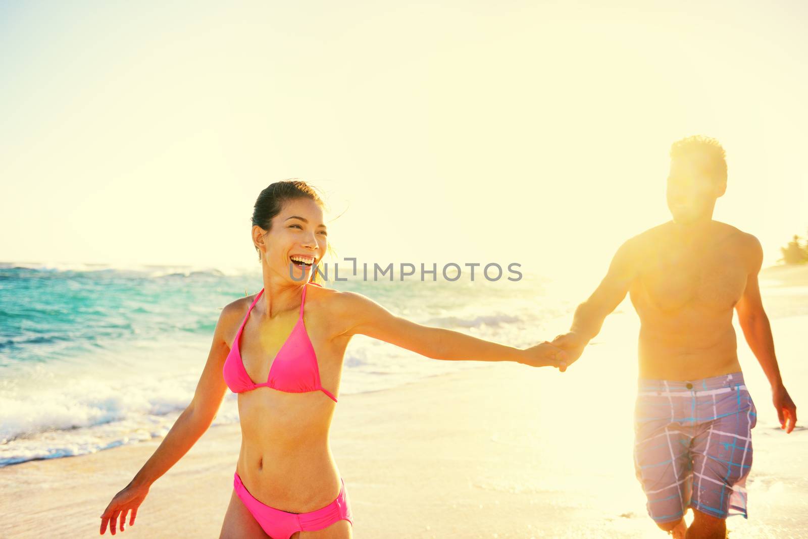 Laughing romantic couple summer vacation beach fun by Maridav