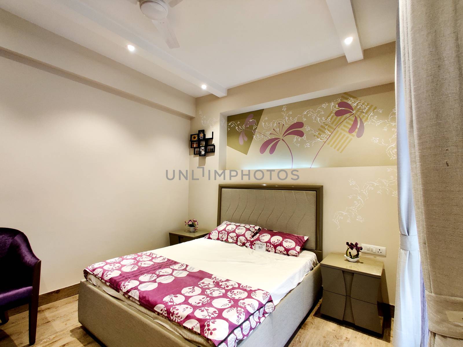 wide angle shot of a modern well designed bedroom with great lighting. Shot at a modern expensive beautifully maintained flat or apartment in Delhi, Gurgaon, Noida for premium individuals. Shows the real estate of India