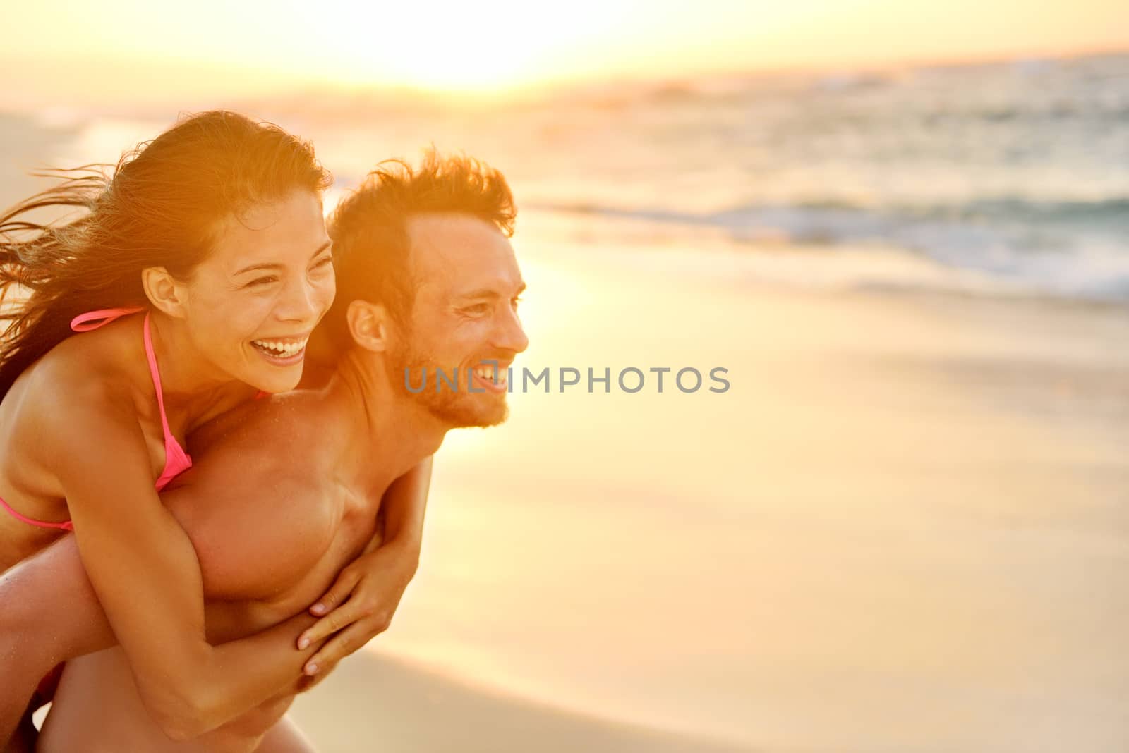 Lovers couple in love having fun on beach portrait by Maridav