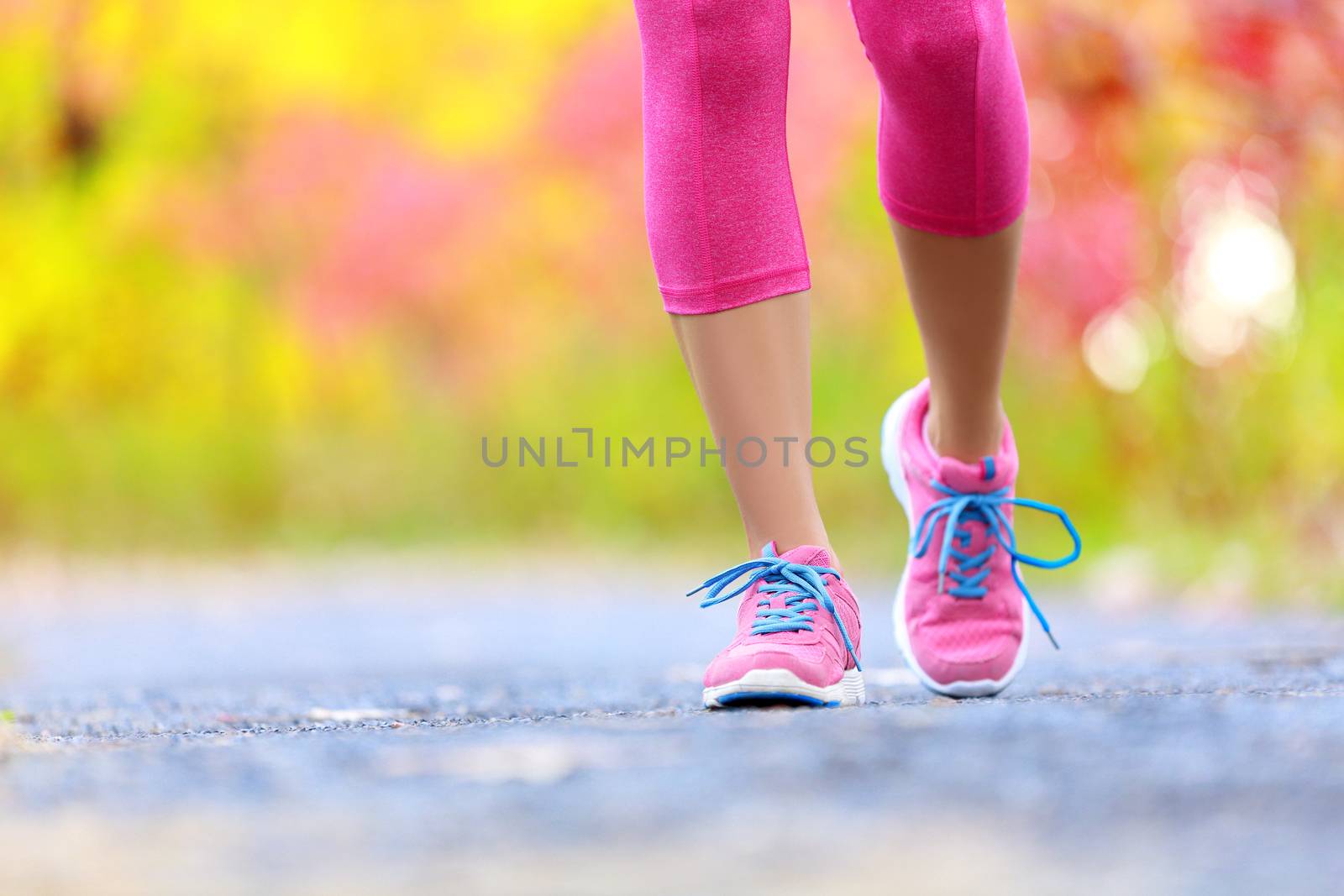 Jogging woman with athletic legs and running shoes by Maridav
