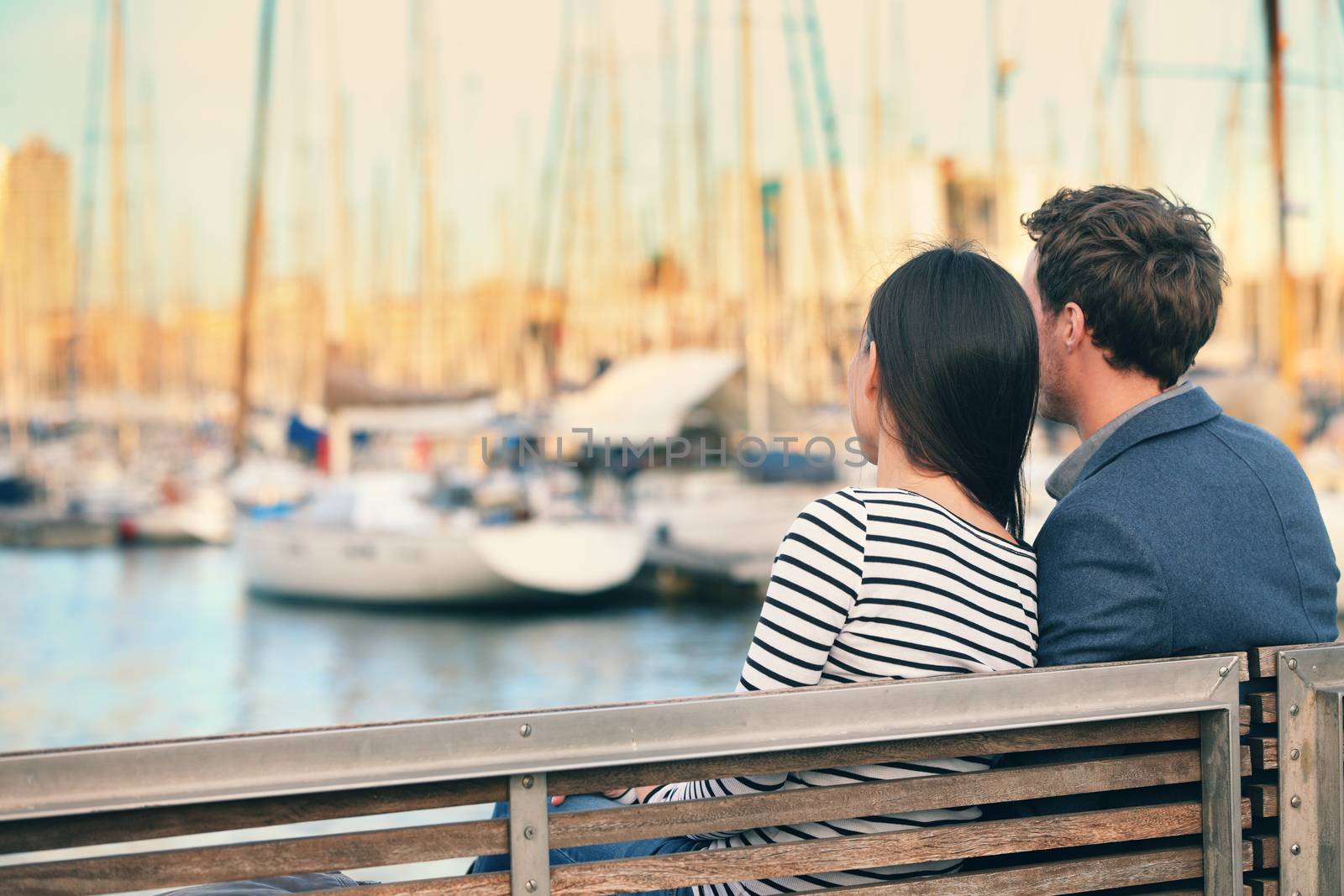 Lovers couple dating on bench in harbour Barcelona by Maridav