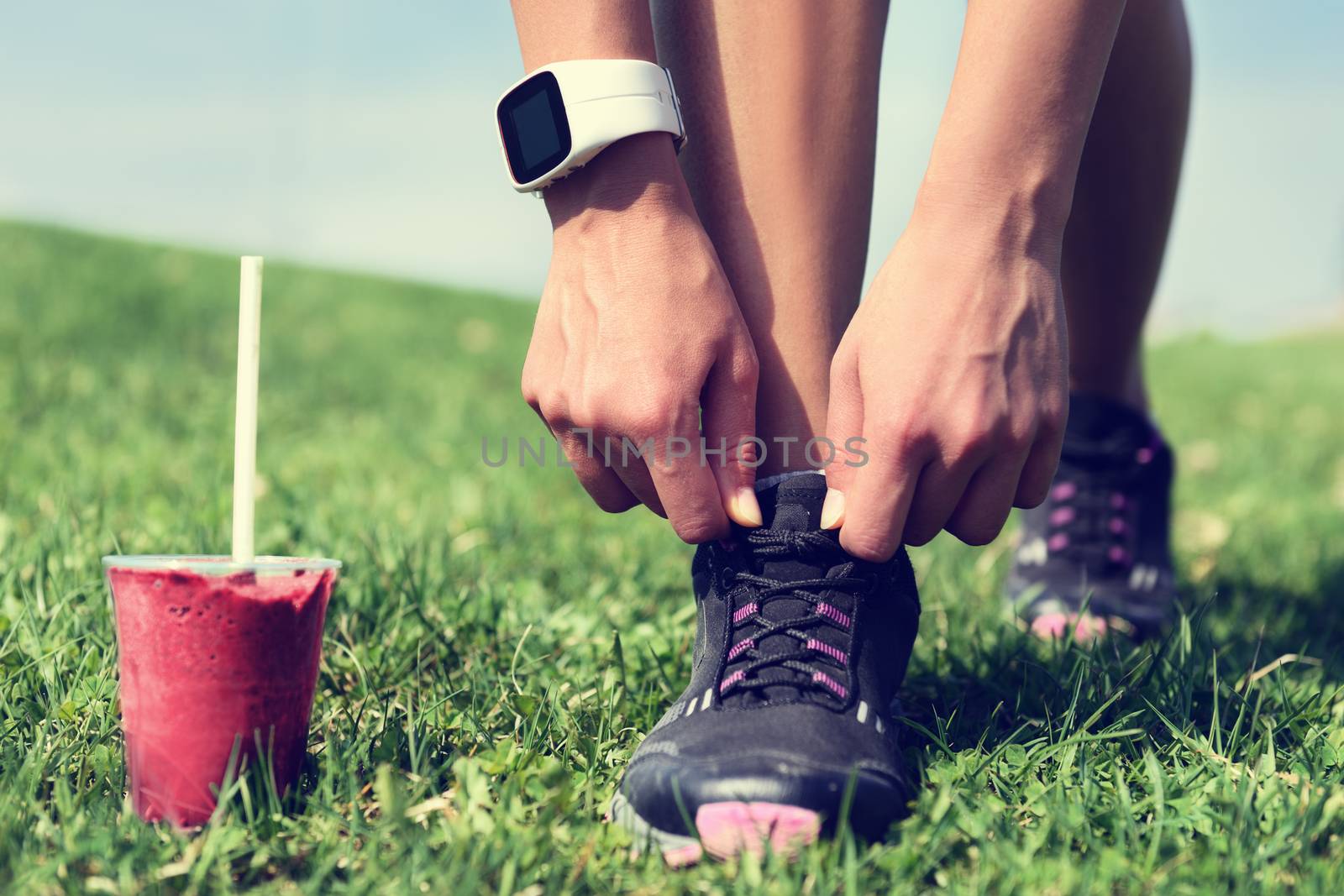 Weight loss - runner tying laces with smoothie by Maridav