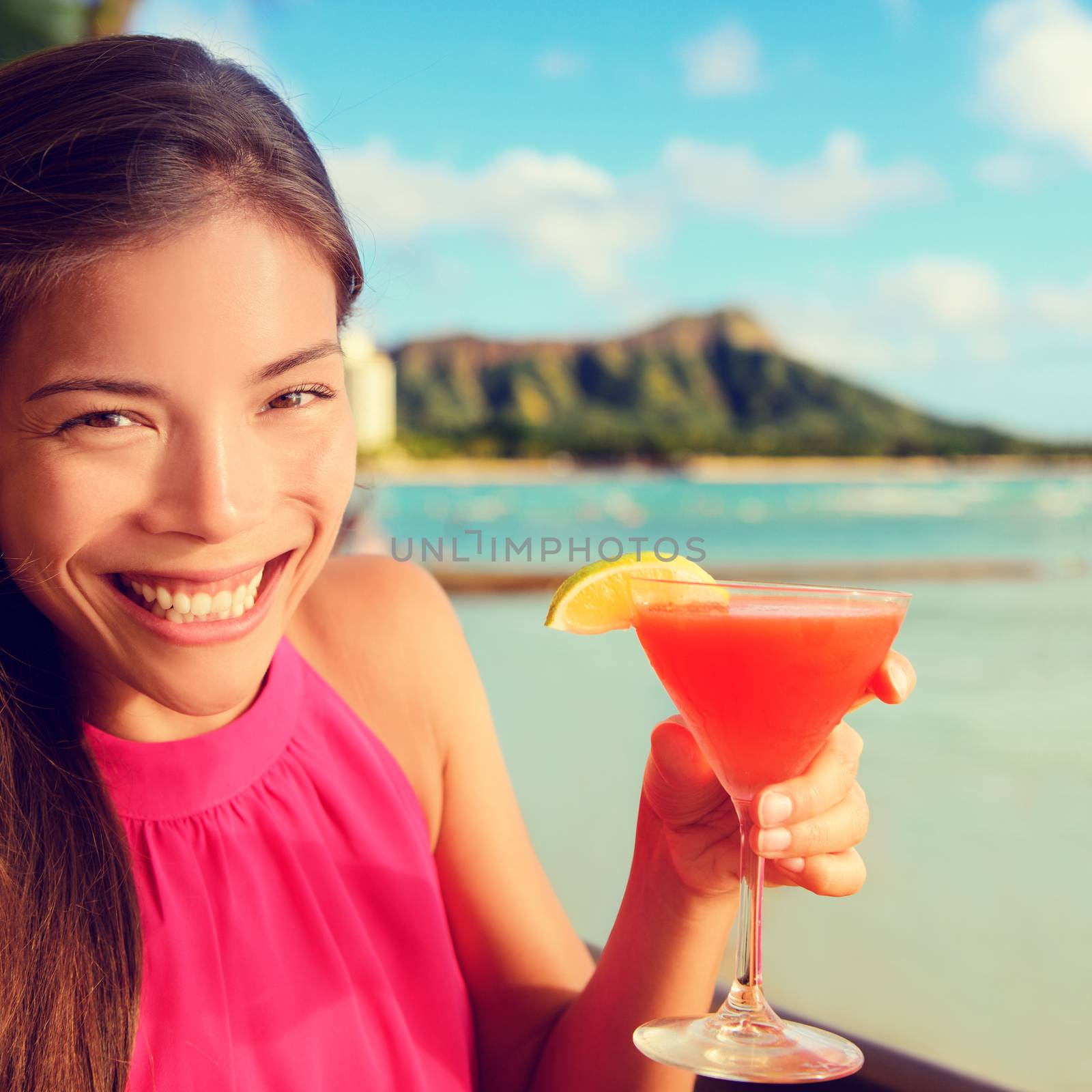 Woman drinking cocktail alcohol drink at beach bar by Maridav