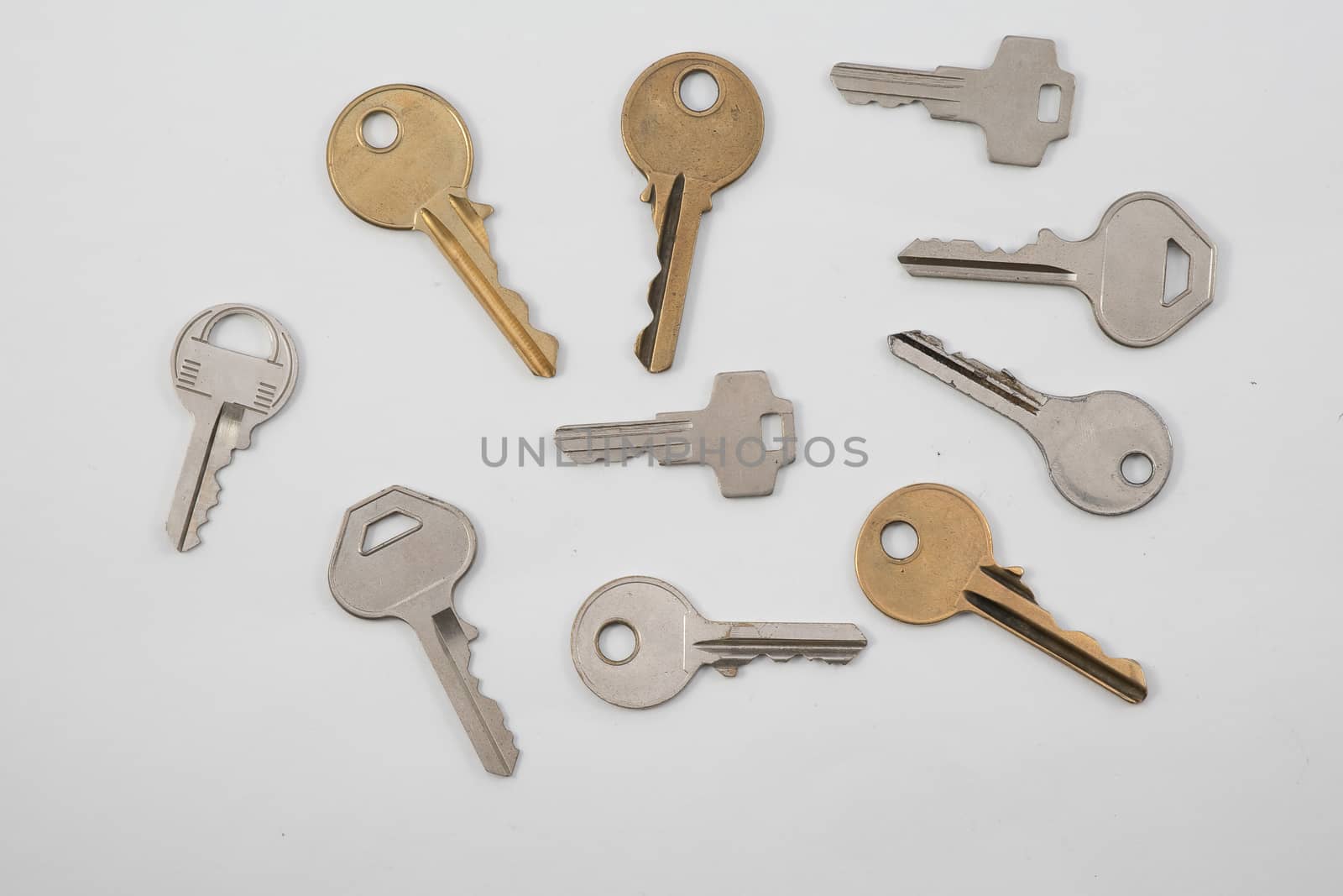 Assortment of keys on plain background