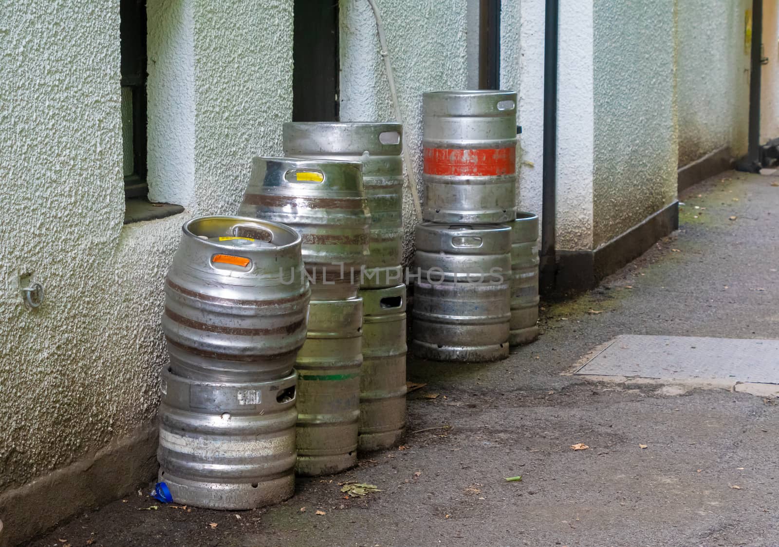 Beer keg barrels stacked outside a building