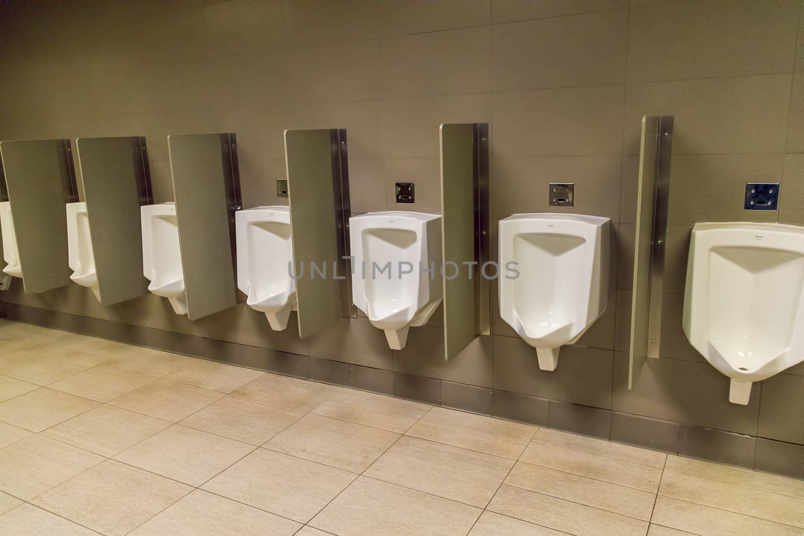 Row of mens urinals on a wall