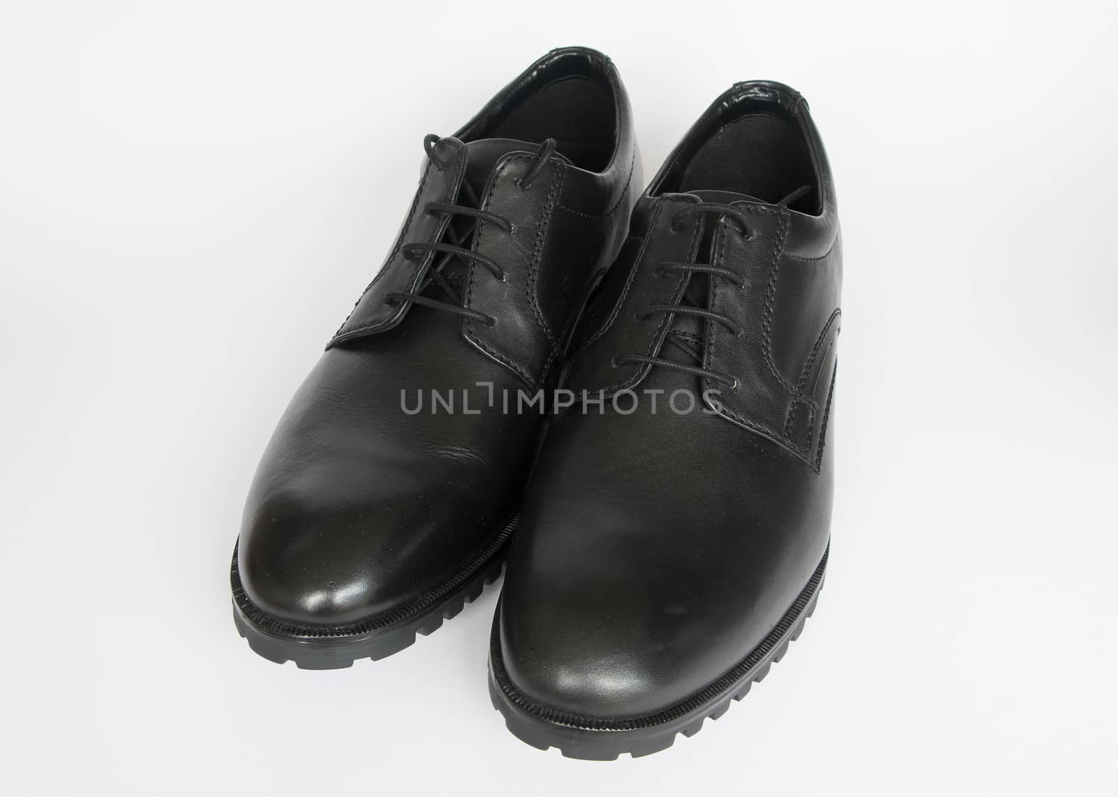 A new pair of mens black shoes isolated on a white background
