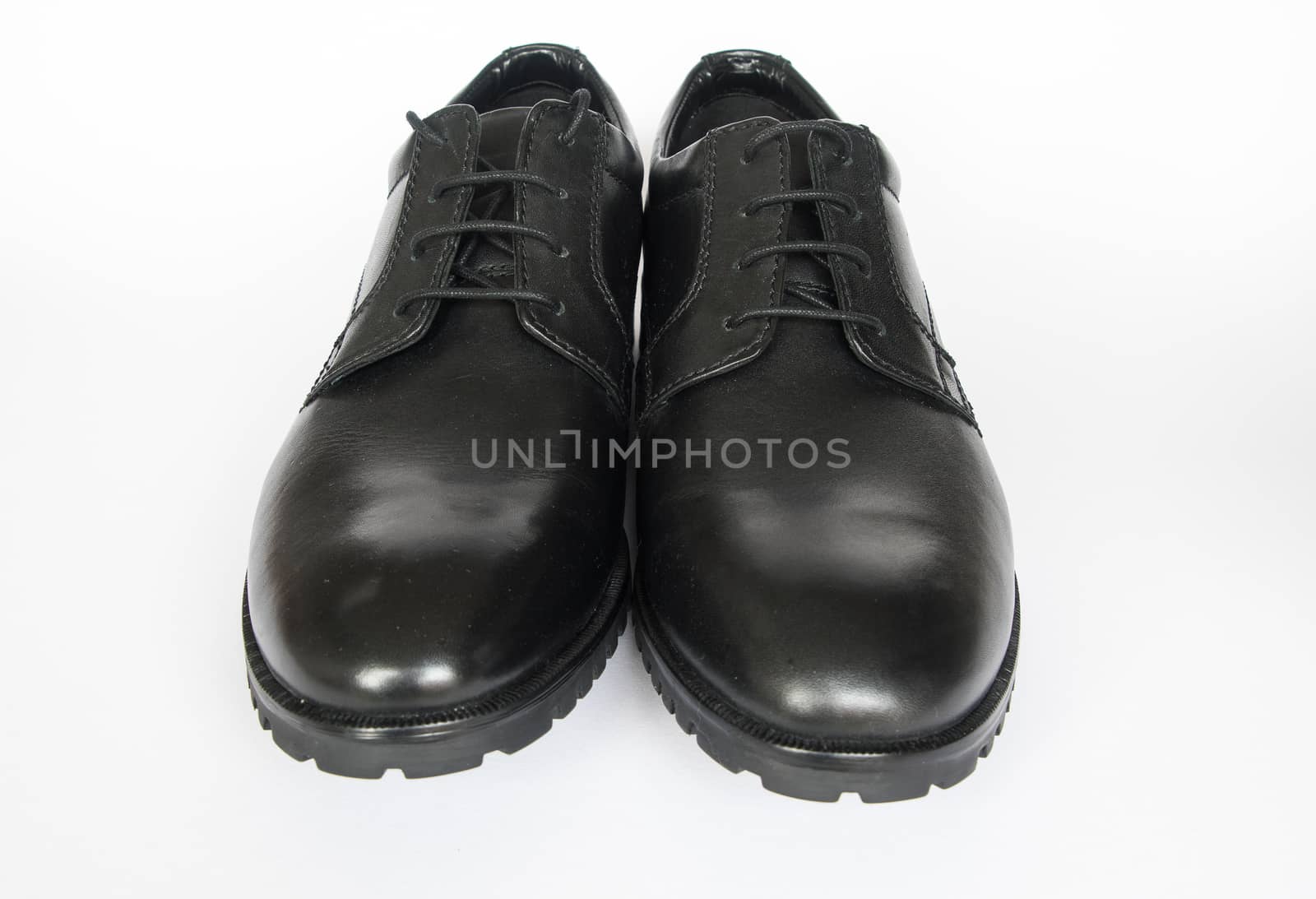 A new pair of mens black shoes isolated on a white background