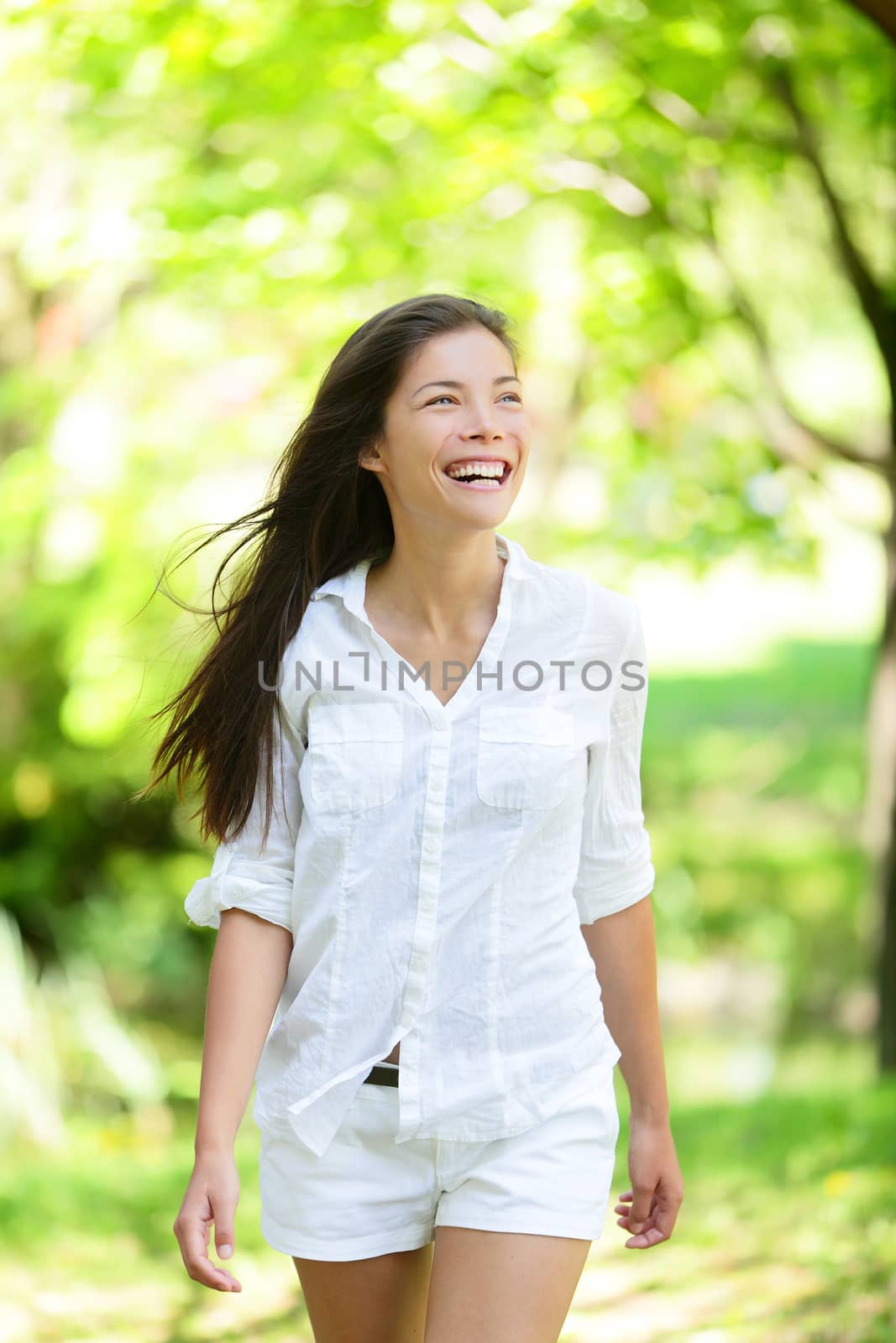 Happy Young Woman Looking Away In Park by Maridav