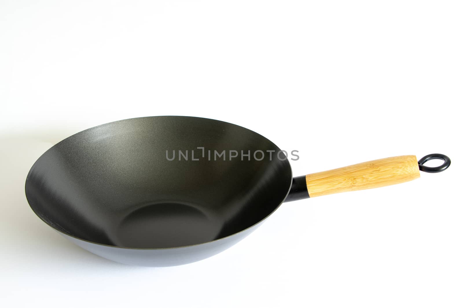 Chinese wok frying pan with wooden handle on a white background