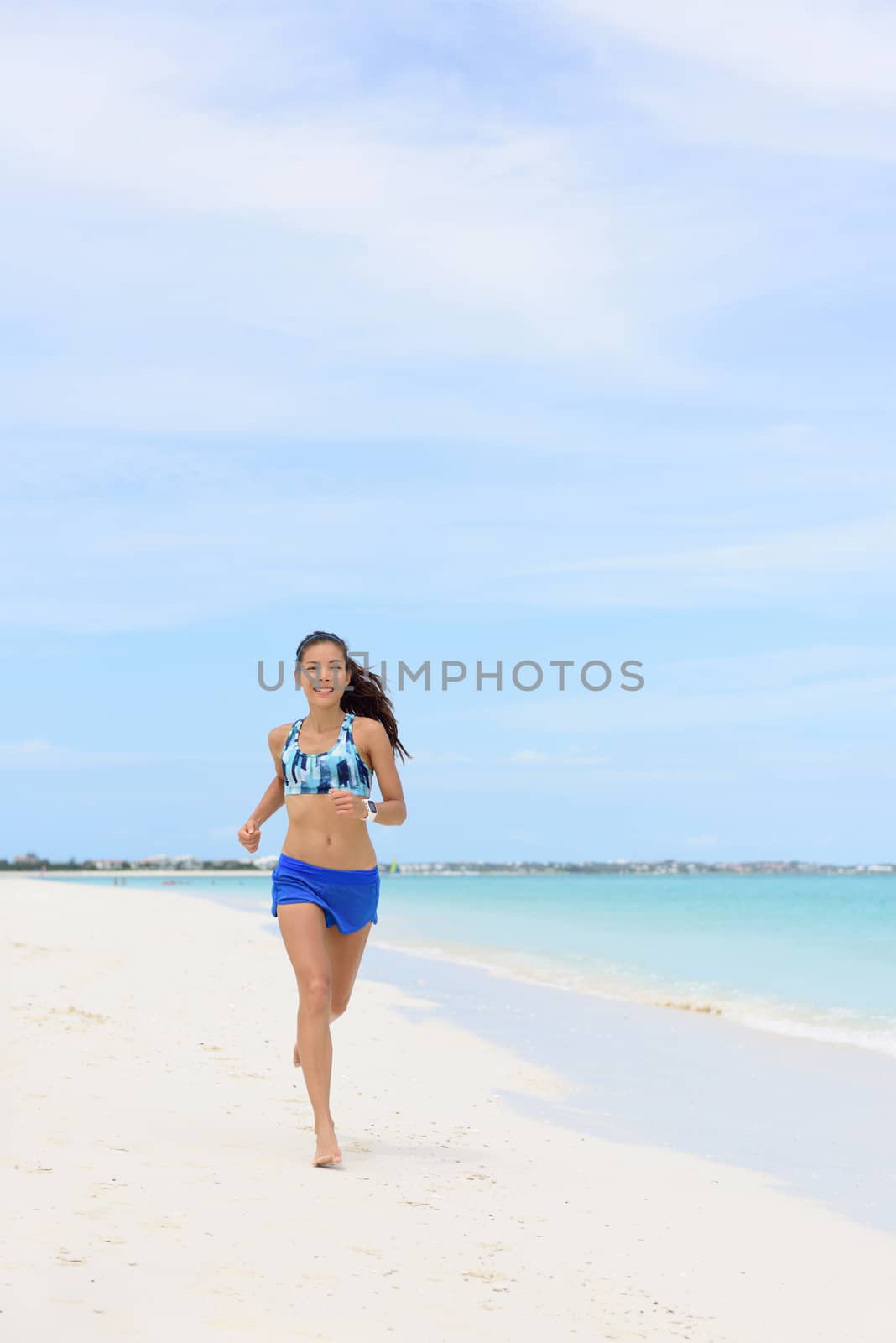 Beach running woman doing morning cardio workout by Maridav