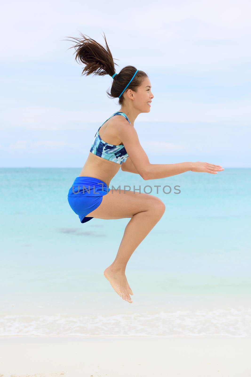Crossfit woman doing jump squat training exercises by Maridav