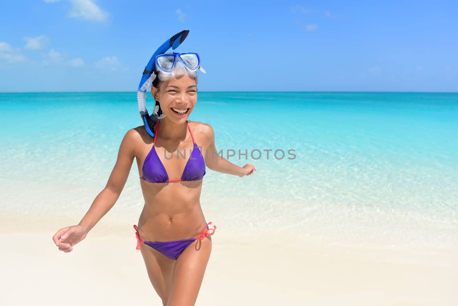 Beach vacations - Asian woman swimming having fun by Maridav