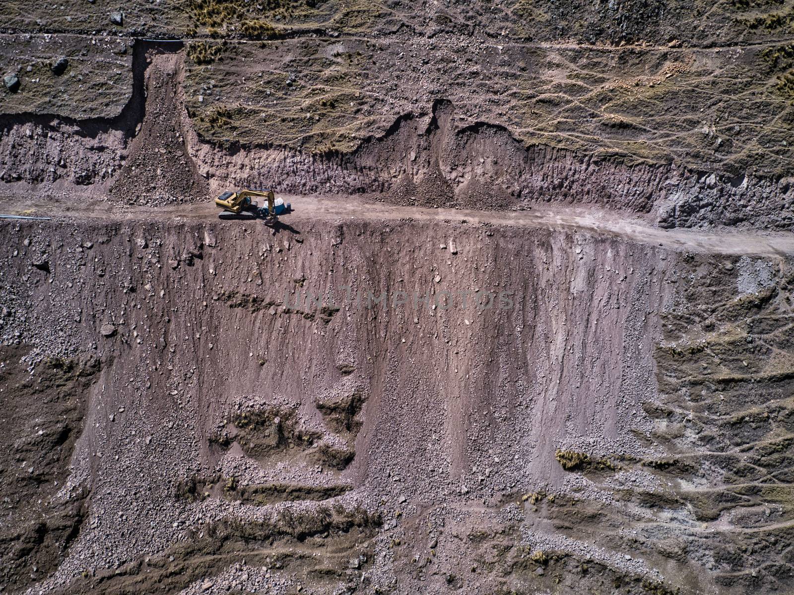 Aerial view of excavator on dangerous high-mountain road in Andes, South America