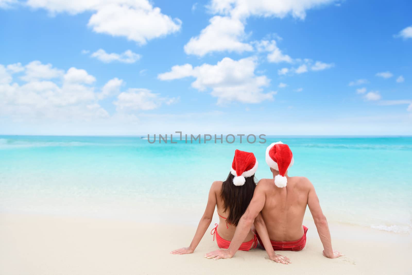Christmas couple in love on travel beach holidays by Maridav