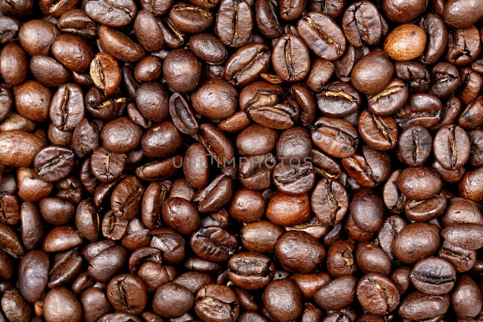 Coffee beans texture background. Closeup of fresh roasted bag of dark roast coffee beans pattern, useful for text copy space, element detail or advertisement background.