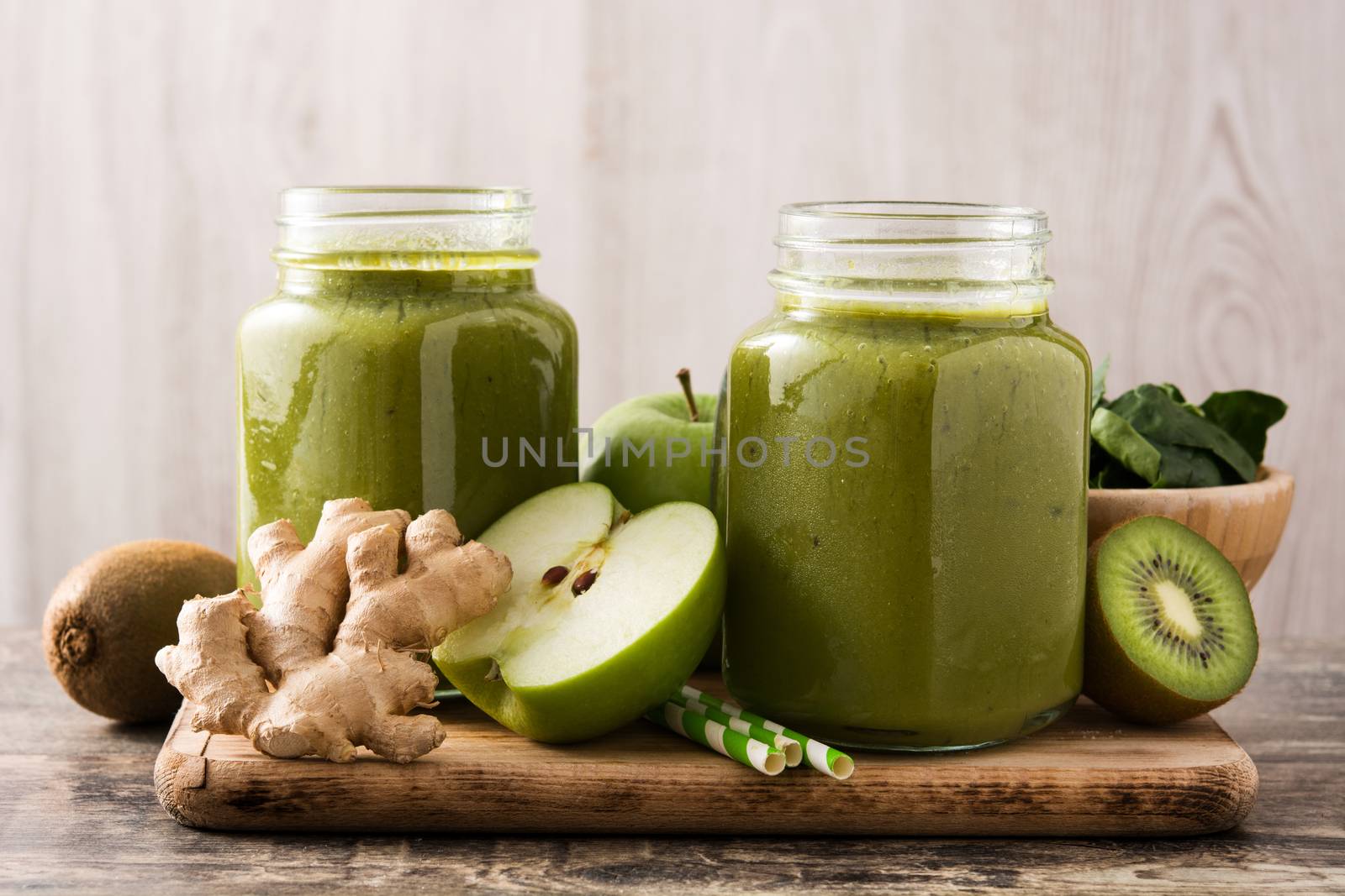 Healthy green smoothie in jar on wooden table