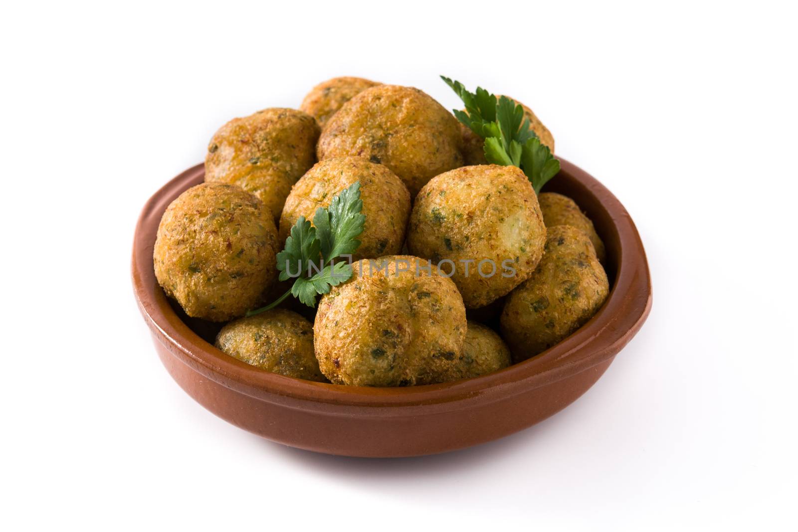 Traditional cod fritters decorated with garlic and parsley isolated on white background
